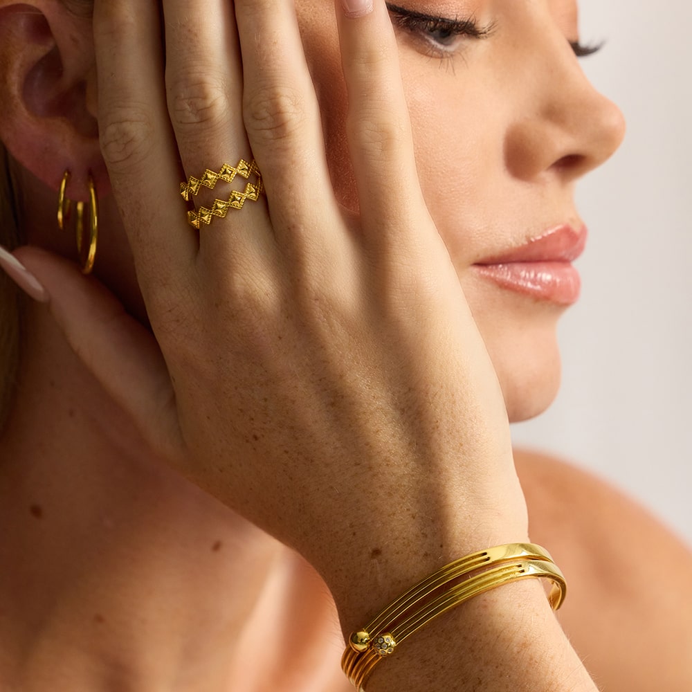 The Tellus Gold Stacking Ring is embellished with a triangular design and is fully size adjustable. Handmade with sustainable materials, this stacking ring is high polished in 18k gold.